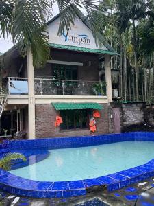 a large swimming pool in front of a building at Sampan Cafe and Resort in Cox's Bazar