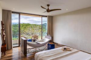 a bedroom with a bed and a tub and a window at Zen Valley Dalat in Da Lat +131 photos