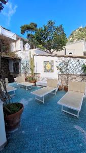 a group of benches sitting on a patio at TERRAZZA Marina Piccola in Capri