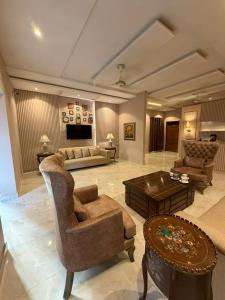 a large living room with a couch and a table at Shelton Hotel Gulberg in Lahore