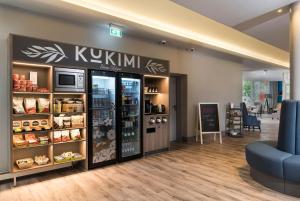 a store with a kkkim sign on the wall at Sunday Hotel Flensburg in Flensburg