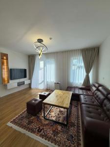 a living room with a leather couch and a table at Modern Luxury Debut - Untouched in Ulaanbaatar