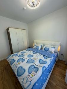 a bedroom with a bed with a blue comforter at Modern Luxury Debut - Untouched in Ulaanbaatar