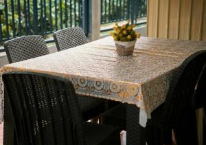 a table with a table cloth with a plant on it at Negradas Transient Inn-with Air-conditioning in Manolo Fortich