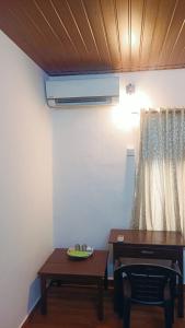 a room with a desk and a table and a table sidx sidx sidx at Ebenezer Stay in Trivandrum +32 photos