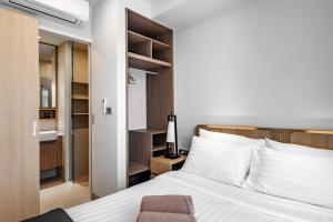 a bedroom with a white bed and a bathroom at Skypark by Villacarte in Laguna Phuket +72 photos