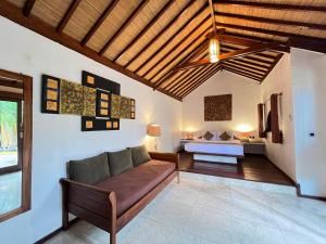a living room with a couch and a bed at Laguna Gili in Gili Trawangan +21 photos