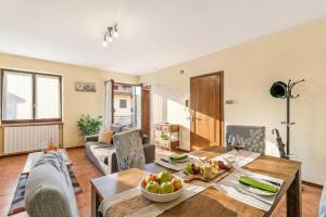 a living room with a table with a bowl of fruit on it at Sunrise in Baveno: Apartment for 4 with Balcony - Happy Rentals in Baveno