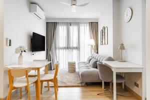a living room with a couch and a table at Skypark by Villacarte in Laguna Phuket