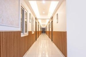 an empty hallway of a building with wood paneling at Treebo Maple Delite in Lucknow