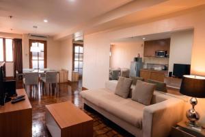 a living room with a couch and a kitchen at Prince Plaza II Condotel in Manila