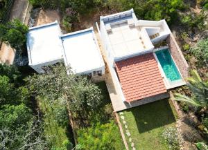 an aerial view of a house with a swimming pool at Little Maua - Stylish Private Hideaway on Galu Beach in Galu