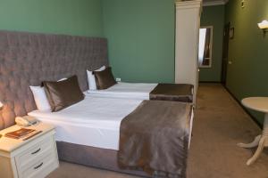 a bedroom with a large bed with a large headboard at Kazakhstan Express in Almaty