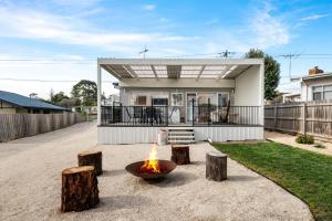 a fire pit in front of a house at Mellow mountains, boutique beach house in Portarlington