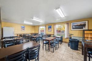 a restaurant with tables and chairs and a refrigerator at Travelodge by Wyndham Kanab in Kanab