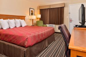 a hotel room with a bed and a television at Econo Lodge Kennewick Tri-Cities in Kennewick