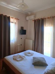a bedroom with a bed with two towels on it at Cozy country house in Preveza