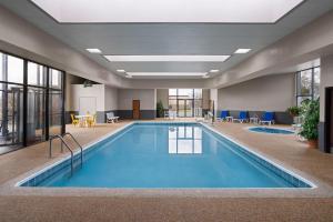 a pool in a hotel lobby with blue water at Wingate by Wyndham Cranberry in Cranberry Township