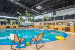 a large pool with chairs and a frisbee at Radisson Hotel Montreal Airport in Ville Saint Laurent