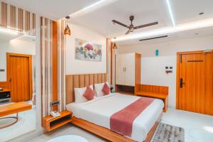 a hotel room with a bed and a bathroom at Travinities Hotel Shree Ji Palace in Ujjain