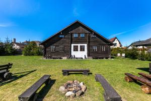 a log cabin with a fire pit in front of it at Penzion Sněžná Volary in Volary +49 photos