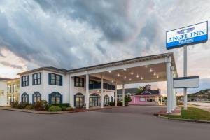 a gas station with a sign in front of it at Angel Inn Near IMAX, a Travelodge by Wyndham in Branson