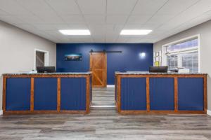 an empty office with blue walls and a door at Angel Inn Near IMAX, a Travelodge by Wyndham in Branson +47 photos