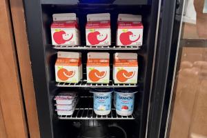 a refrigerator filled with yogurt and other food items at Baymont by Wyndham Findlay in Findlay