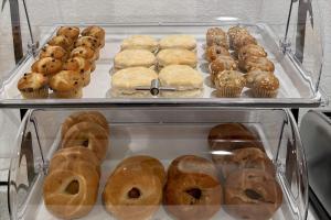 a display case filled with lots of donuts and muffins at Baymont by Wyndham Findlay in Findlay