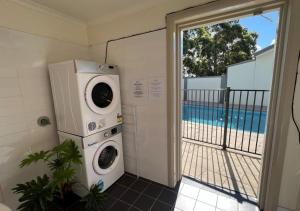 a washer and dryer in a room with a balcony at Hunter Gateway Motel in Maitland