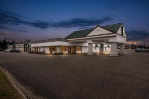a large building with a parking lot in front of it at Quality Inn & Suites in Grayling