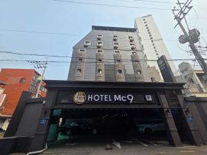 a hotel mcu sign in front of a building at Mc9Hotel in Uijeongbu