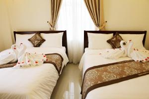 Кровать или кровати в номере Quang Trung Phu Quoc Hotel