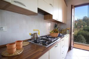 a kitchen with a stove top oven in a kitchen at Sunflower - Lake Maggiore Duplex w/ Terrace and Shared Pool in Lesa