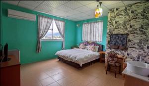 a bedroom with green walls and a bed and a sink at Moonlight Manor B&B in Taitung City +13 photos