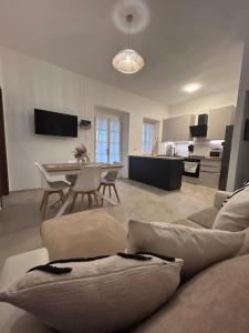 a living room with a couch and a table at Lantana's house in Tertenìa