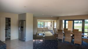 a kitchen and dining room with a table and chairs at Tuscany Downs Estate in Darfield
