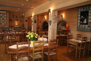 un comedor con mesas y sillas en un restaurante en Auberge du Lac, en Xonrupt-Longemer