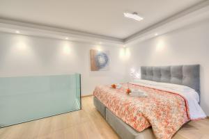 a bedroom with a bed and a painting on the wall at Rebecca Garden with Terrace in Paradiso - Happy Rentals in Lugano