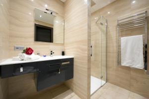 a bathroom with a sink and a glass shower at Rebecca Garden with Terrace in Paradiso - Happy Rentals in Lugano +26 photos