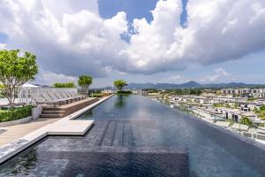 a view of a river with buildings in the background at Skypark by Villacarte in Laguna Phuket