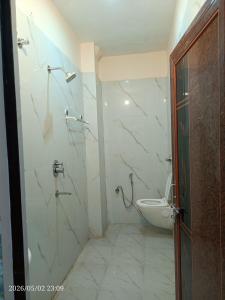 a bathroom with a shower and a toilet in it at Kedarnath villa in Kakarmatha