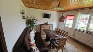 a living room with a couch and a table at Cheia House in Cheia
