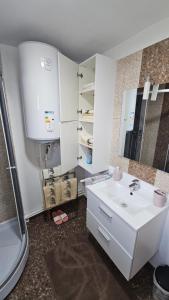 a bathroom with a white sink and a shower at Cheia House in Cheia +41 photos