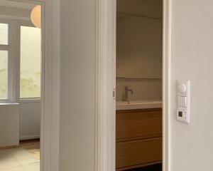 a bathroom with a sink and a bath tub at Cozy Scandinavian design apartment in Bergen