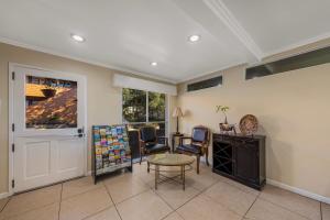 a room with a table and chairs and a door at Clarion Collection Carmel Oaks Inn in Carmel
