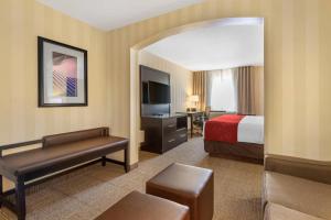 a hotel room with a bed and a desk with a television at Comfort Suites Highlands Ranch Denver Tech Center Area in Highlands Ranch