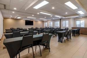 a conference room with tables and chairs and a screen at Comfort Suites Highlands Ranch Denver Tech Center Area in Highlands Ranch
