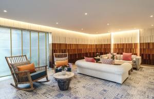 a living room with two couches and two chairs at DoubleTree by Hilton Phuket Banthai Resort in Patong Beach