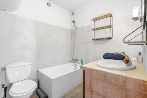 a white bathroom with a toilet and a sink at Le Domaines Des Thermes - T2 in Gap